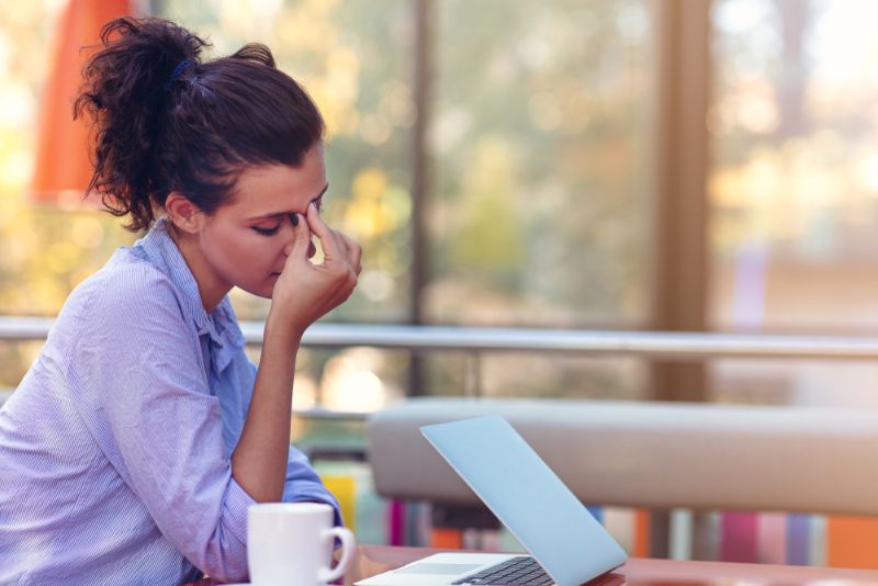 stressed woman working on her laptop