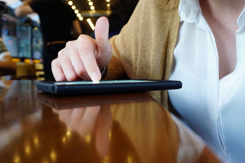 Woman scrolling social media in cafe